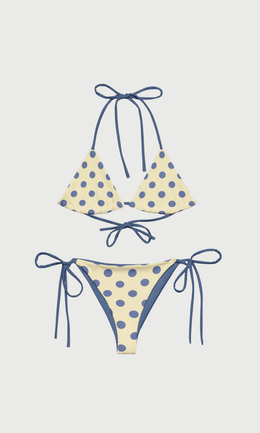 Polka dot bikini set with blue straps on a light gray background