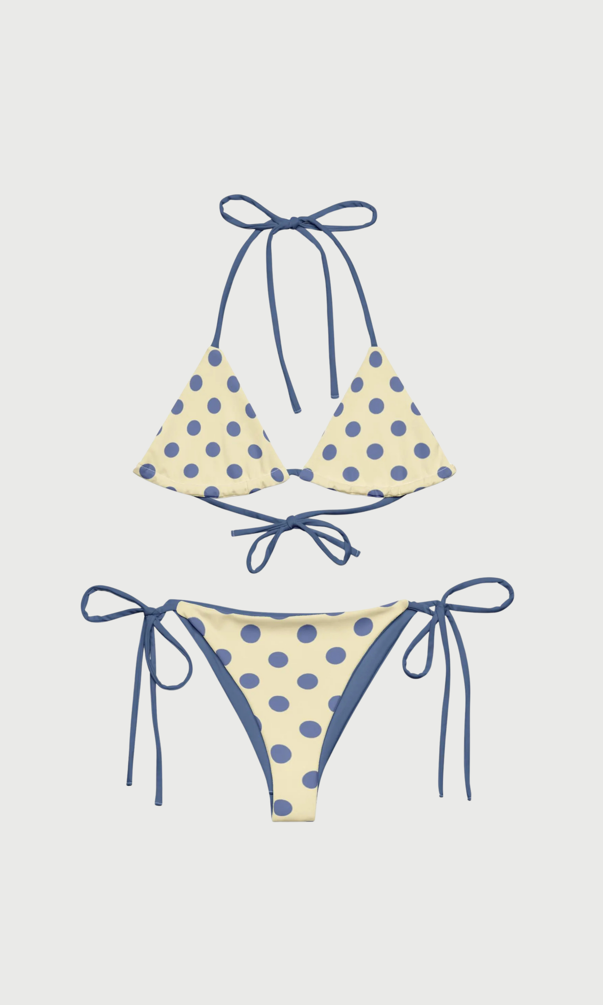 Polka dot bikini set with blue straps on a light gray background